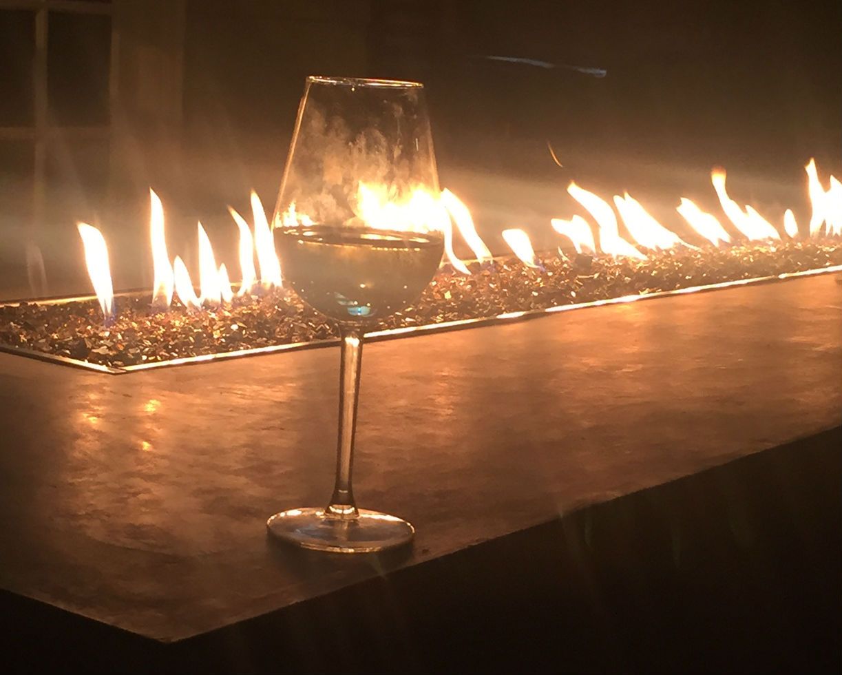 wine glass in front of a long flaming table for events
