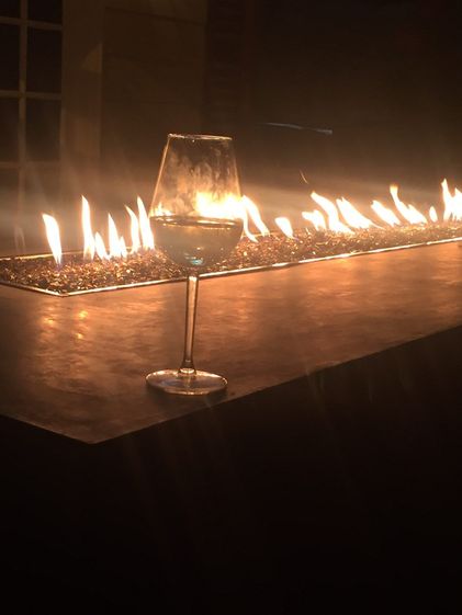 wine glass in front of flaming table